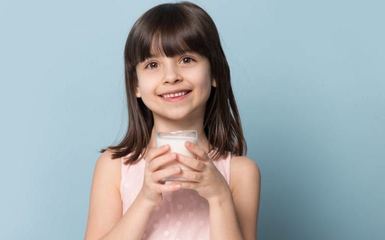 Child Drinking Milk With Clean Smile